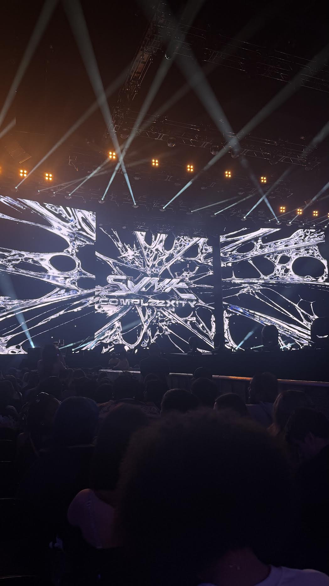 The SYNK: COMPLaeXITY stage and light beams at Kaseya Center